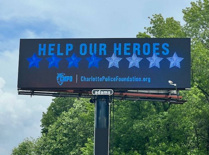 Adams Outdoor Advertising had put up billboards throughout Charlotte that read “Help Our Heroes” with four dark blue and four light blue stars representing the eight officers killed and wounded while serving a warrant on Monday. Hood Hargett Breakfast Club